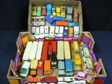 a cardboard box filled with assorted toy cars