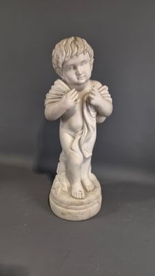 a statue of a boy holding a bird in his hands