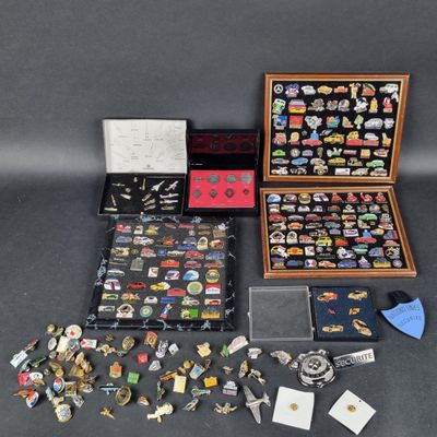 an assortment of pins and brooches in a wooden case