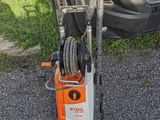 a car that is parked next to a power washer on the side of the road