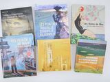 several books on a white table with a white background