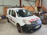 a white van with a red stripe parked in a garage