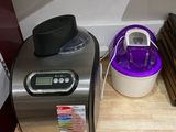 a small counter with a blender and other items on it