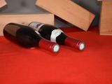 two bottles of wine sitting next to each other on a table