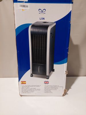 an image of a black and white air cooler sitting on top of a white table