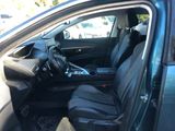 the interior of a car with the door open and the driver ' s seat down