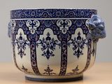 a blue and white bowl with a bird head on it