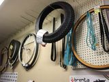many different types of bicycle tires hanging on the wall