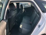 the back seat of a white car with the door open