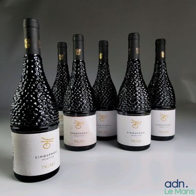 six bouteilles de vin sont alignées sur une table