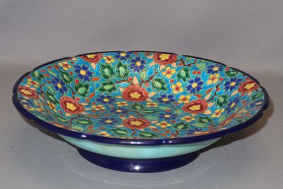 a blue bowl with a colorful floral design on it
