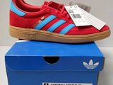 a pair of red and blue adidas sneakers sitting on top of a blue box