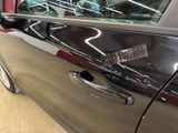 a close up of a car door handle with a sticker on it