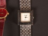 two watches sitting next to each other on a table