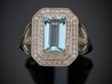 gros plan d'une bague avec une topaze bleue entourée de diamants
