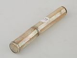 an old silver and gold telescope on a white surface