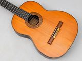 an image of a guitar with a wooden case on a white surface