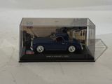 the toy car is in a clear box on a white surface