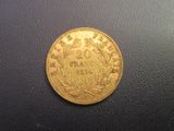 a close up of a gold coin on a black surface