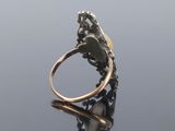 a close up of a gold and silver ring on a reflective surface