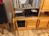 a record shelf with a lot of records on top of it