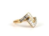 a gold and diamond ring with two rows of diamonds