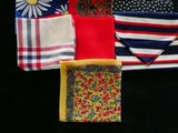 many different types of handkerchiefs laid out on a black surface