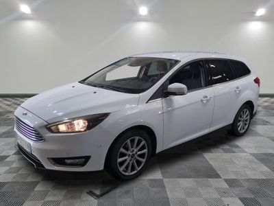 the white ford focus is parked in a large room