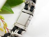 a black and white bracelet with a silver clasp
