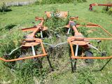 four lawn mowers that are sitting in the grass