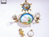 a clock with a picture of a fish on it hanging from a wall