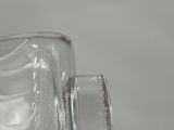 a person holding a glass of water in their hand