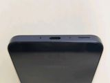 the back of a black samsung phone sitting on top of a table