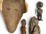 an image of a collection of african artifacts including a statue, figurine, and other items