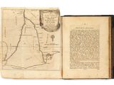 an open book with a map on it sitting on top of a table
