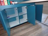a blue cabinet that has some books on top of it