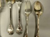 a lot of silver spoons and forks on the table