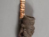 an image of a wooden stick with a carved head on it