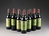 six bottles of red wine lined up in a row