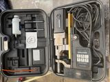 a black case with tools inside of it on the ground