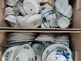 a box full of dishes and bowls in it