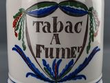 a blue and white cup with a design on it