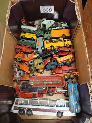 a cardboard box full of toy cars and trucks