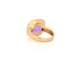 a close up of a gold ring with a purple stone