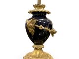 a black and gold vase with a bird on it