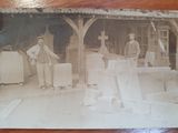 an old photo of two men standing next to each other on a table
