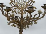 a large metal candelier with a clock on it