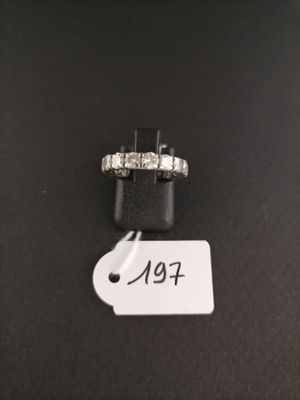 a close up of a ring with a price tag on a table
