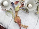 a table with a bunch of flowers and a candle holder on it