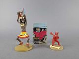 figurines of a woman in a dress and a man in a costume